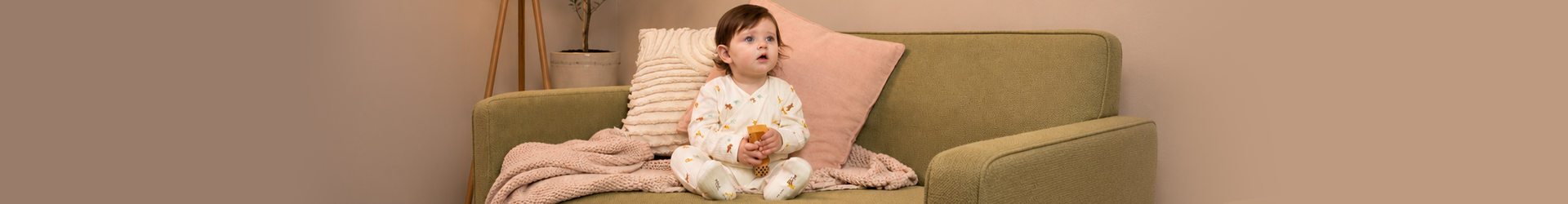 Babies sitting on a bed